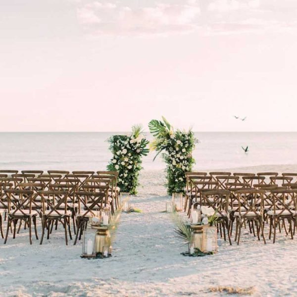Beach wedding ceremony with cross back chair rentals from Niche Event Rentals | Kaity Brawley Photography