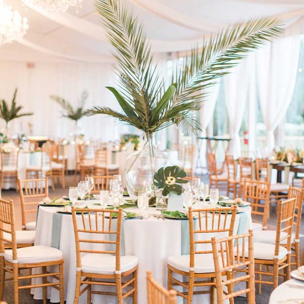 Tropical wedding reception with natural Chiavari chair rentals from Niche Event Rentals | The Hendricks Photo