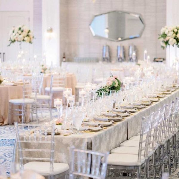 Wedding reception with long tables and clear Chiavari chair rentals | Hunter Ryan Photo | Niche Event Rentals