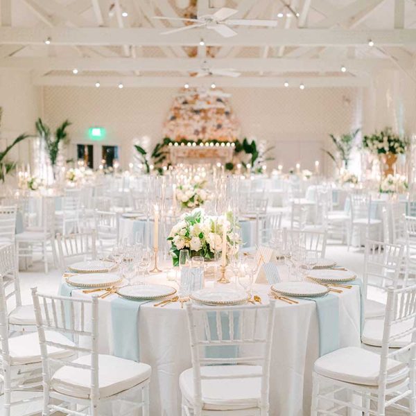 White and pastel blue wedding reception table settings with white Chiavari chair rentals from Niche Event Rentals | Laura Foote Photography